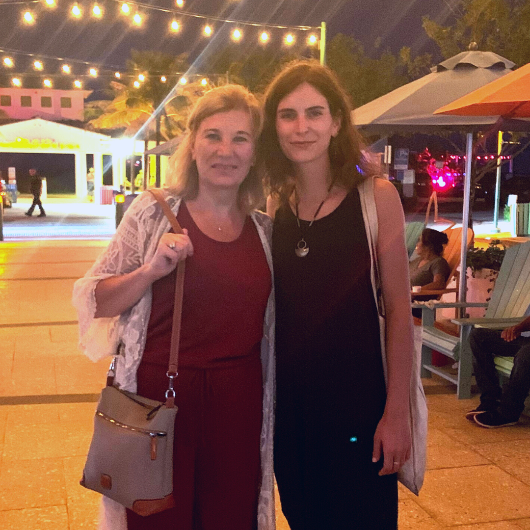 two ladies hugging at a carnival